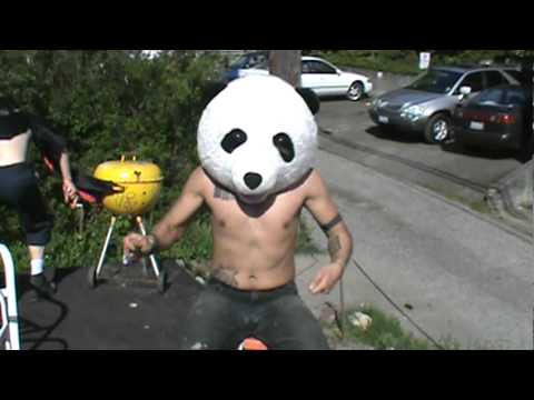 Guy with panda head plays air drums